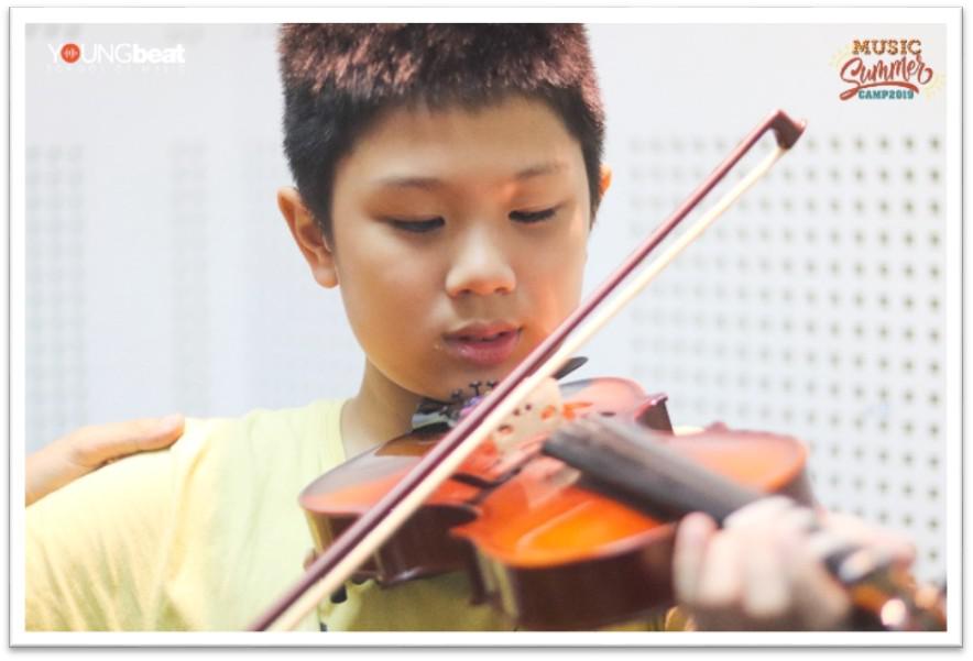 Hình 2: Hình ảnh bạn Quang Minh (học viên lớp D1 Trung Hòa) trong tiết học làm quen với Violin